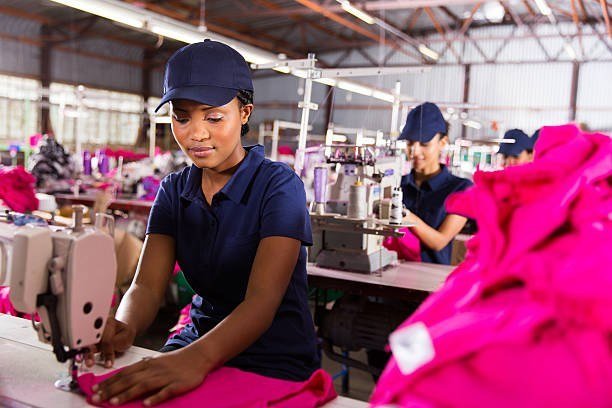 Team member sewing bright branded garments